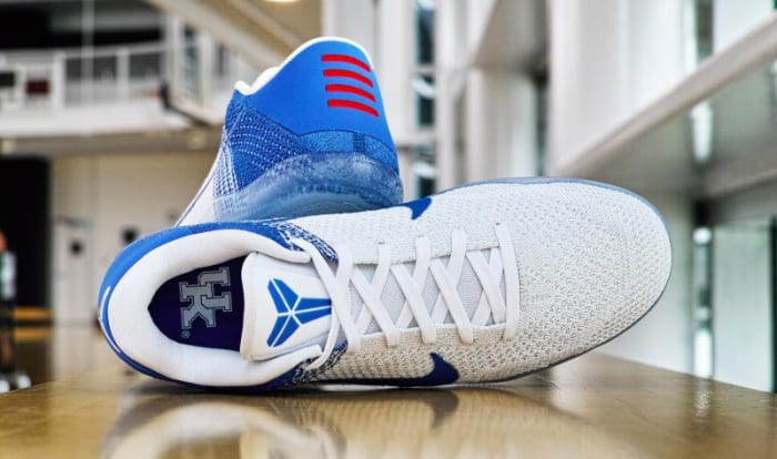 Side view of Kentucky-branded Nike Kobe shoes.